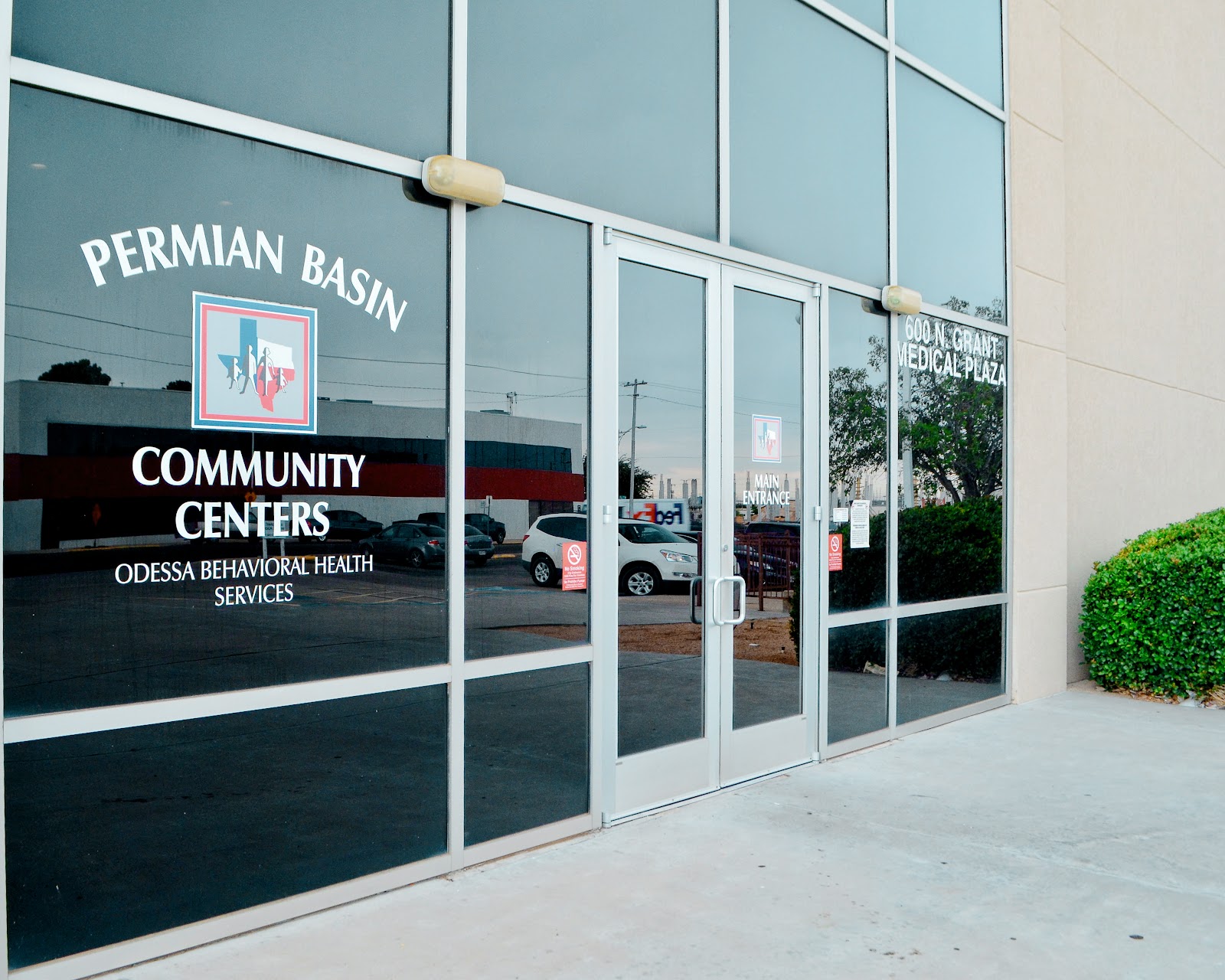 Exterior storefront showing Permian Basin Community Centers entrance with glass doors and signage