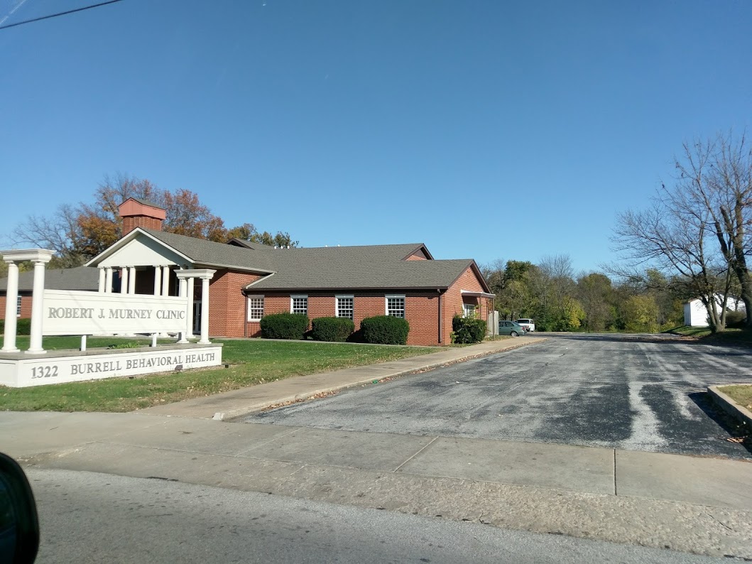Exterior view of Robert J. Murney Clinic brick building with signage, driveway, and landscaping