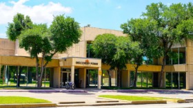 Exterior of Discovery Point Retreat facility showing yellow storefront entrance with glass doors and windows