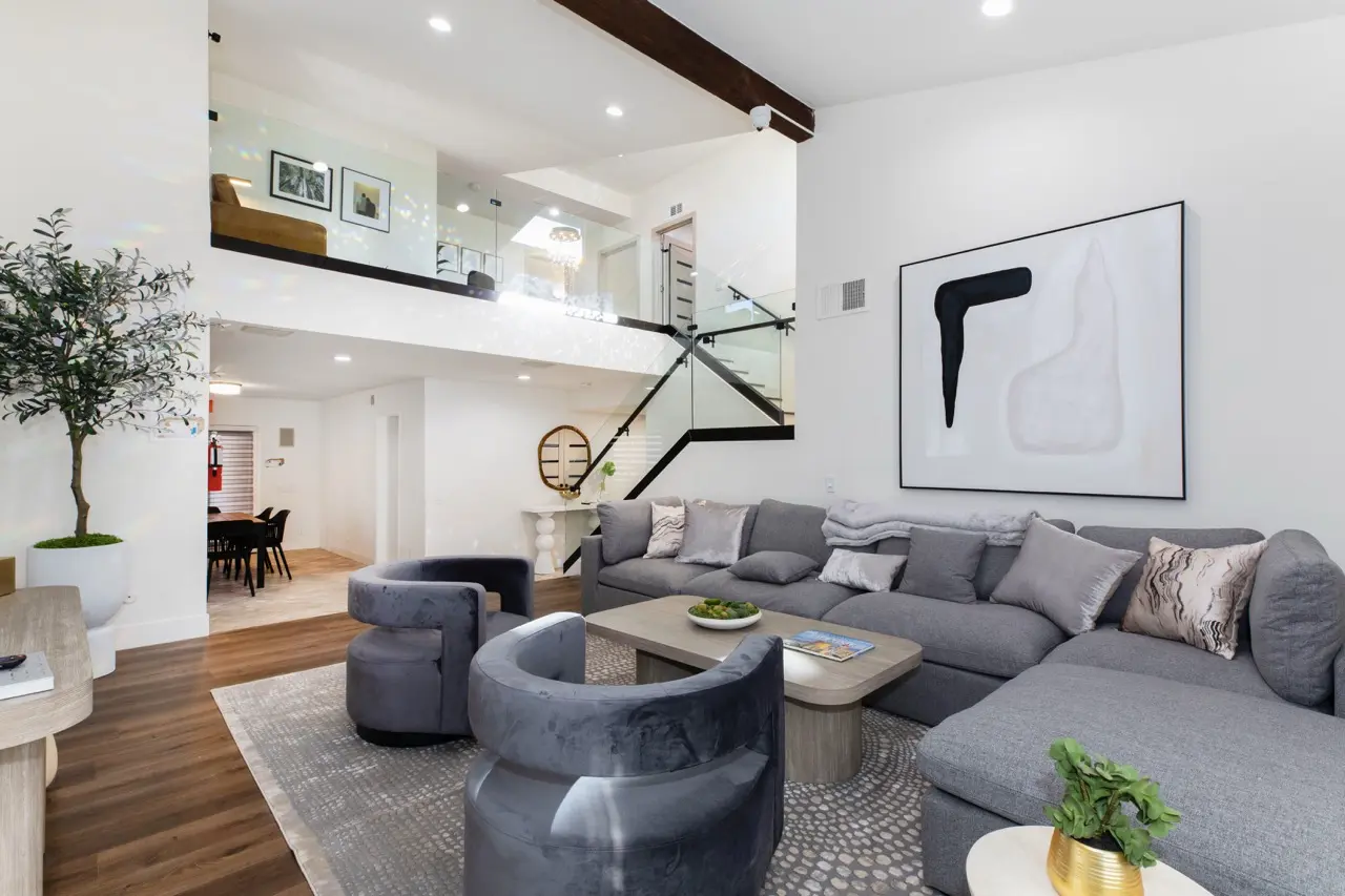 Spacious interior living room area at Calabasas Recovery Center, featuring a large gray sectional sofa and modern decor.