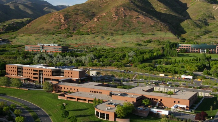 Aerial view of treatment center campus showing multiple buildings, landscaped grounds, and mountain surroundings