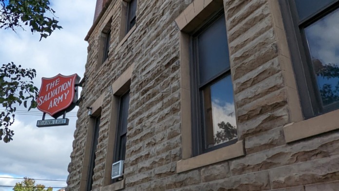 Exterior stone facade showing lower levels of building with windows and architectural detailing
