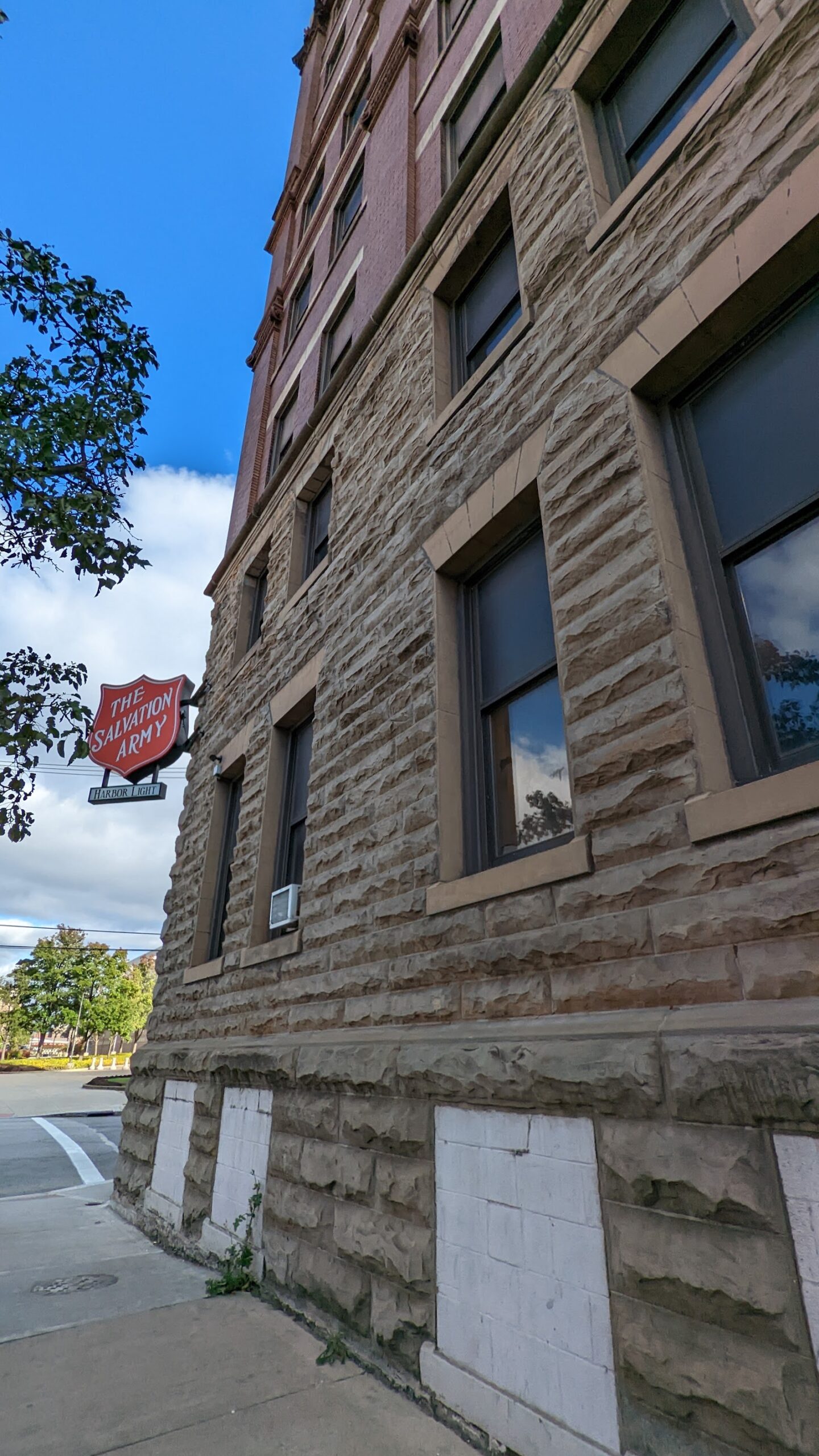 Exterior stone facade showing lower levels of building with windows and architectural detailing