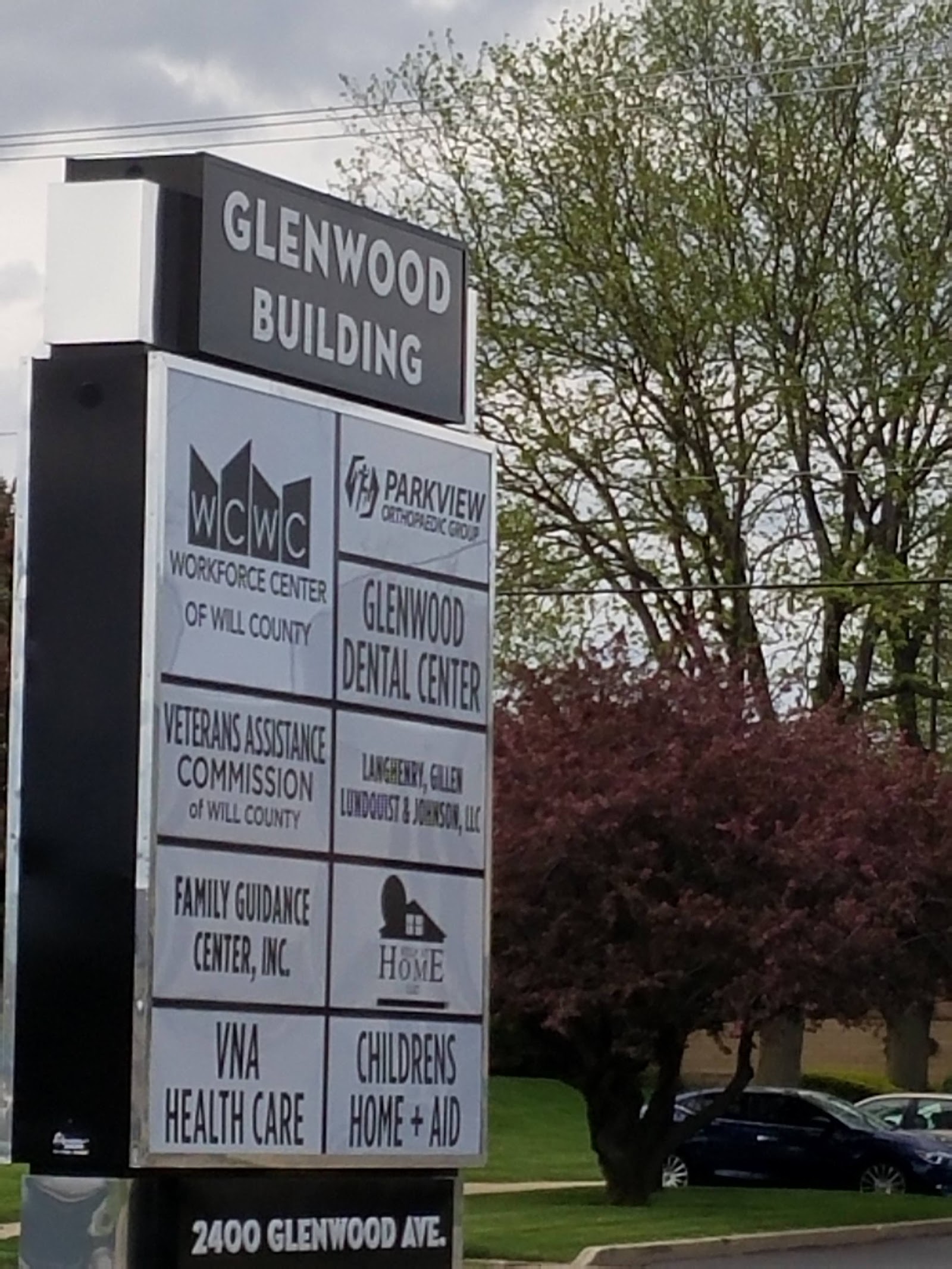 Exterior directory sign listing multiple organizations including Family Guidance Center at Glenwood Building