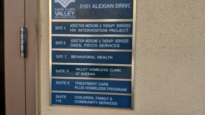 Wall-mounted directory signage showing all facility suites at 2101 Alexian Drive with service descriptions.