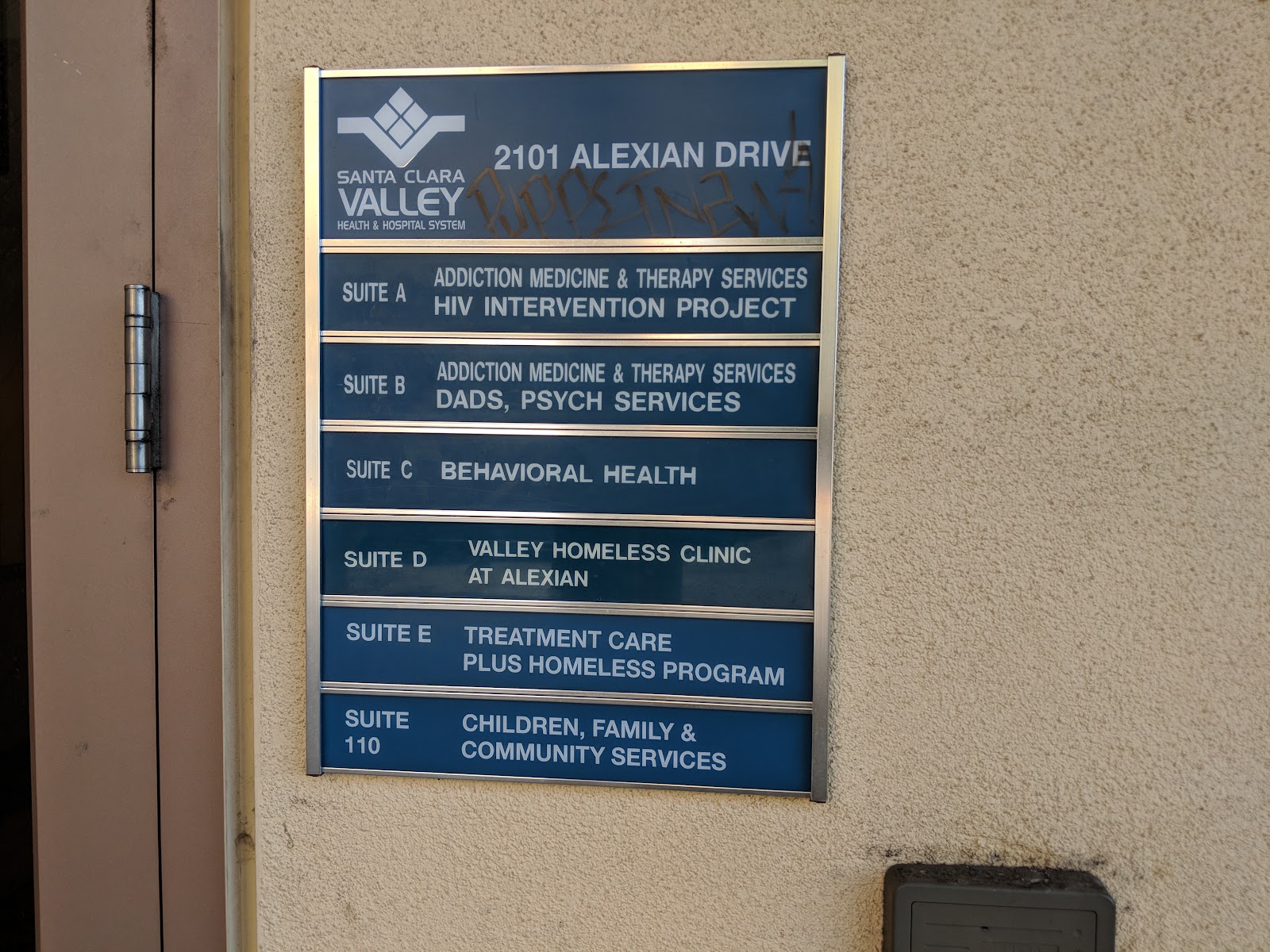 Wall-mounted directory signage showing all facility suites at 2101 Alexian Drive with service descriptions.