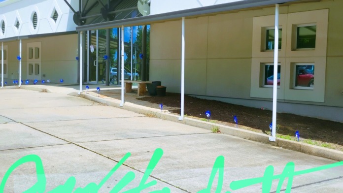 Exterior view of Community Counseling Services facility showing modern tan and white building facade with large windows and covered entrance