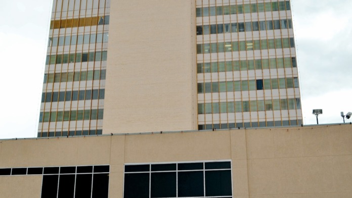 Exterior view of multi-story medical facility building with distinctive tower and signage