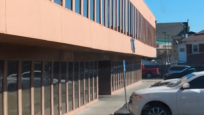 Exterior showing multi-story treatment center building with parking lot and clear glass entryway
