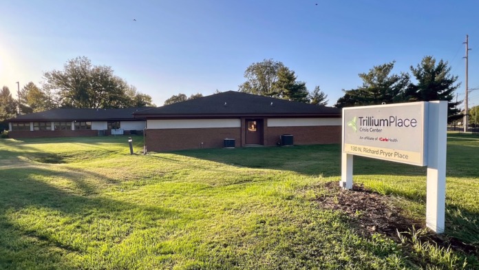 Exterior view of brick building with TrilliumPlace facility sign, grounds, and front entrance area