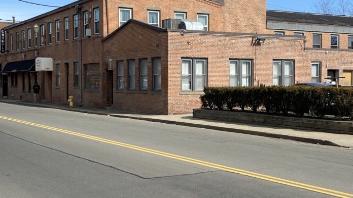 Exterior view of brick rehabilitation center building with multiple windows and entrance doors on East Street