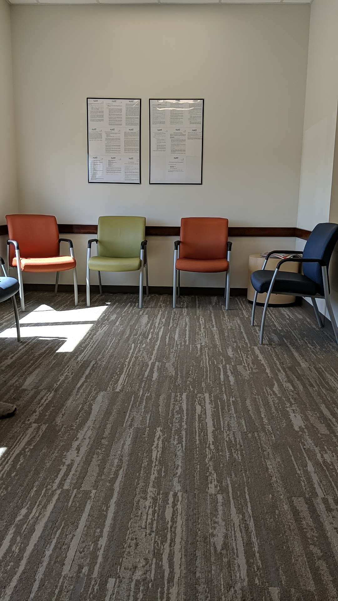 Interior common area with multiple seating options in various colors and calm, welcoming atmosphere