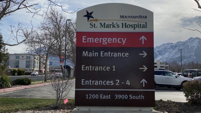 Outdoor directional sign for St. Marks Hospital indicating emergency, main entrance, and other facility entry points