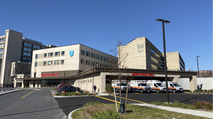 Exterior emergency entrance with covered ambulance bay and modern hospital facility structure