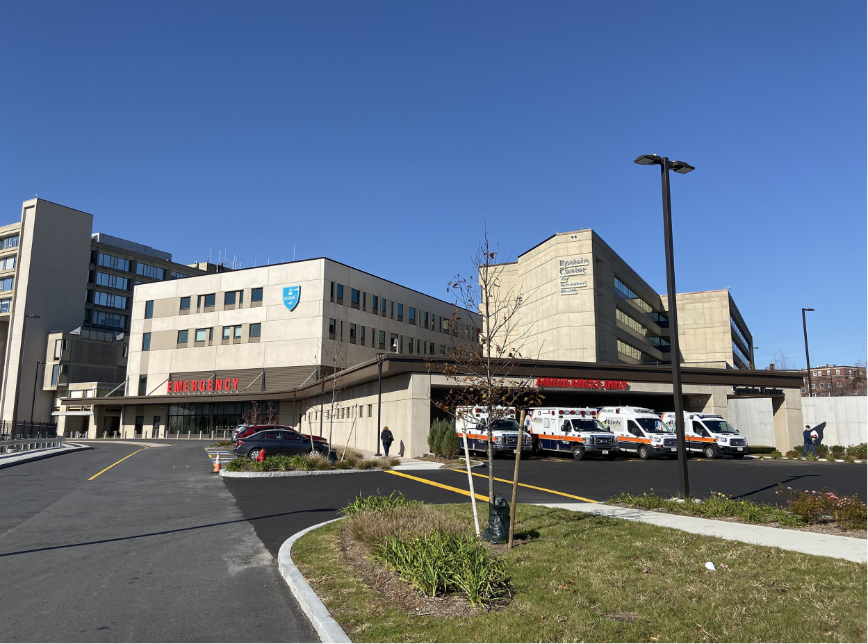 Exterior emergency entrance with covered ambulance bay and modern hospital facility structure