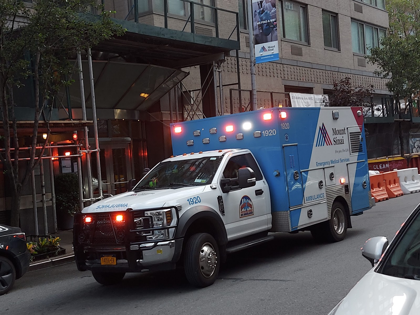 Exterior view of Mount Sinai ambulance stationed outside facility entrance building