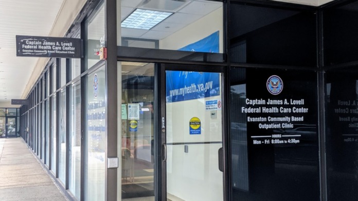 Exterior walkway leading to facility entrance with signage displaying hours of operation and facility name on storefront