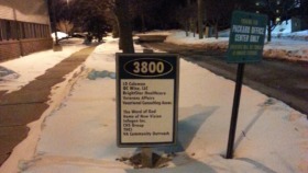 Exterior nighttime view showing facility address marker 3800 and building entrance with snow coverage
