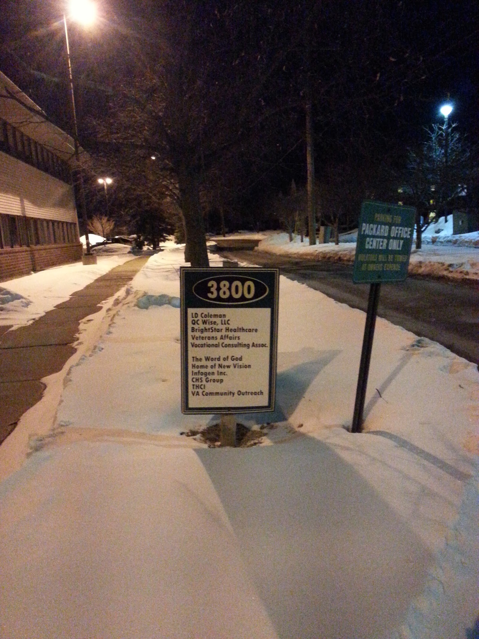 Exterior nighttime view showing facility address marker 3800 and building entrance with snow coverage