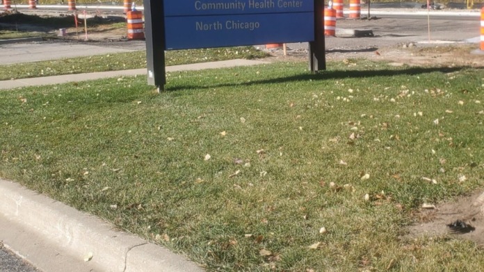 Exterior signage for Lake County Health Department Community Health Center North Chicago with trees and parking area visible
