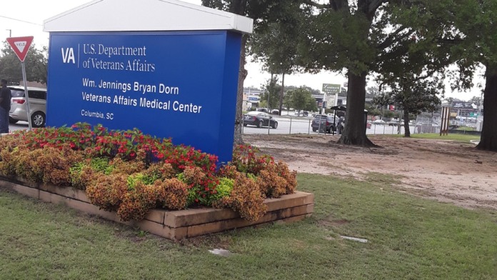 Exterior facility signage for Wm. Jennings Bryan Dorn VA Medical Center with landscaped flower beds and grounds