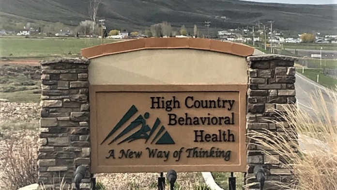 Exterior sign reading High Country Behavioral Health with landscape and mountains visible in background