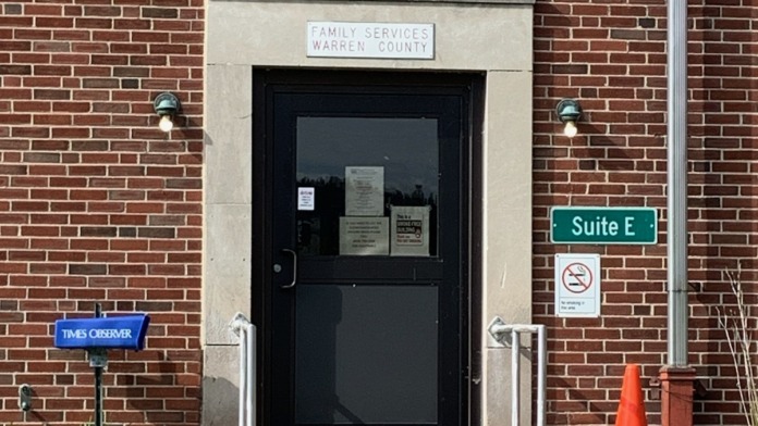 Exterior entrance showing Family Services of Warren County main door with signage, brick facade, and Suite E identification