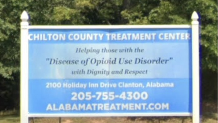 Exterior signage for Chilton County Treatment Center with facility information, address, and phone number displayed on blue sign