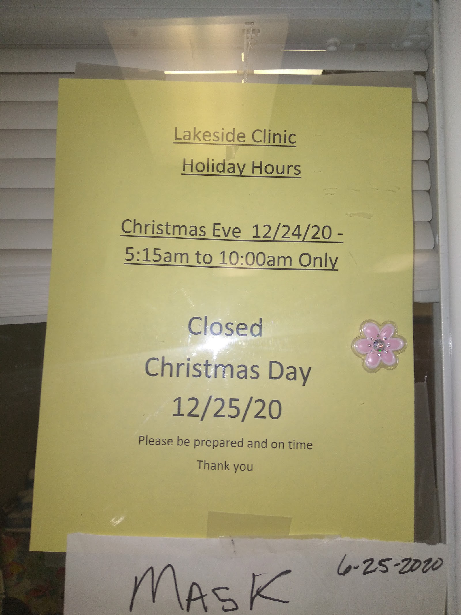 Interior signage displaying Lakeside Clinic holiday hours on yellow posted notice with facility name and closure dates
