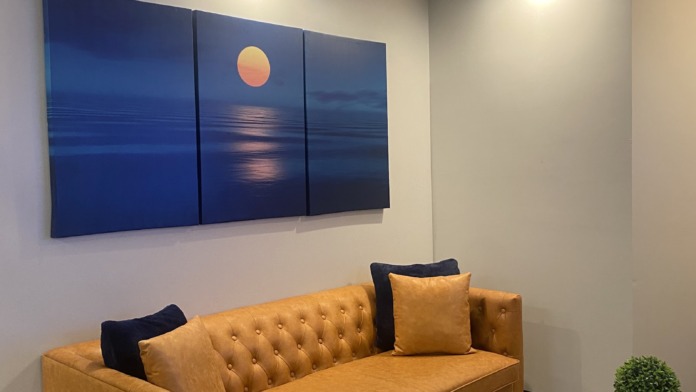 Interior wooden plaque mounted on yellow wall displaying Solstice Pacific mission statement and facility values text
