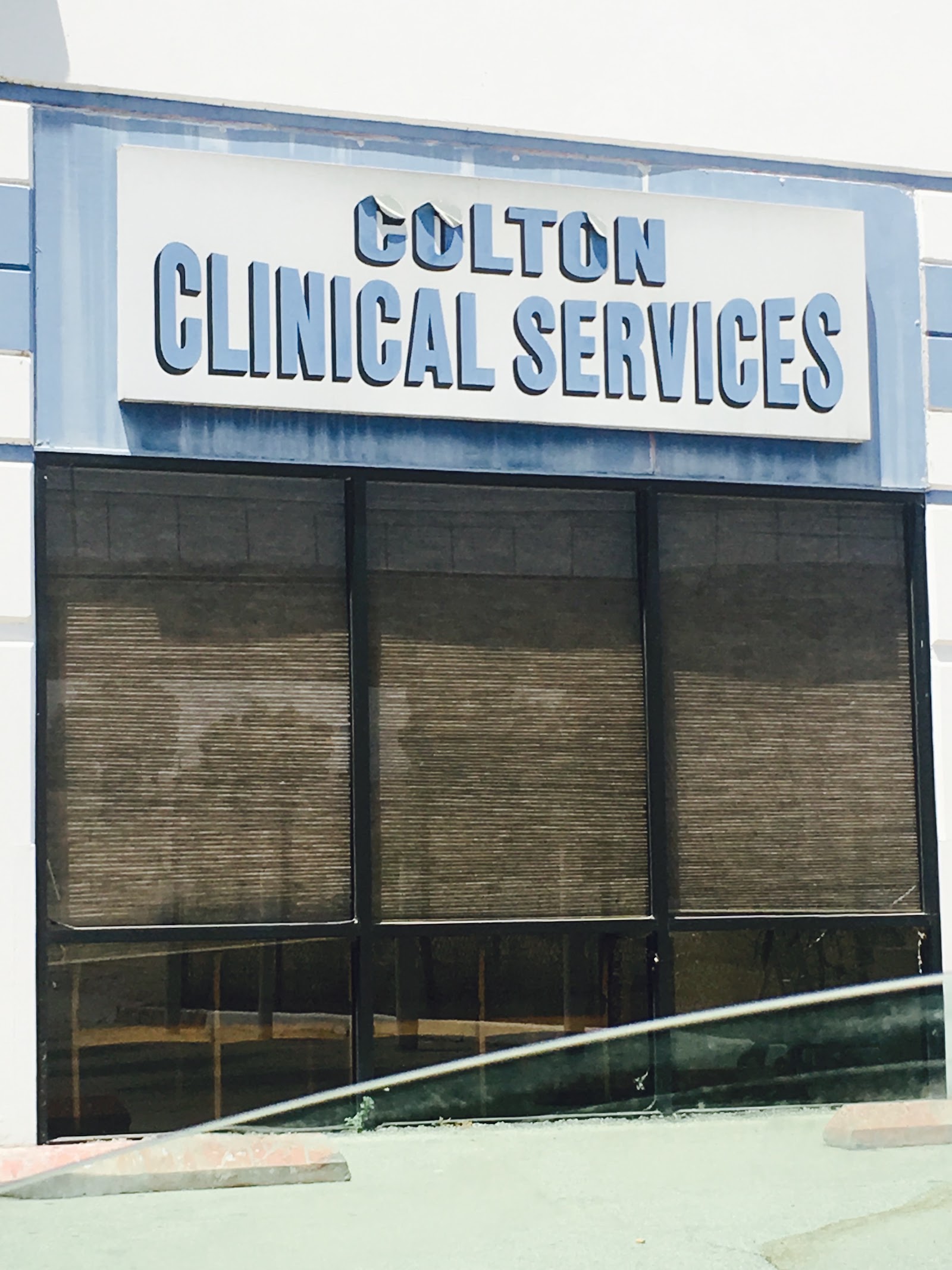 Exterior storefront signage reading Colton Clinical Services with metal frame and shuttered windows.