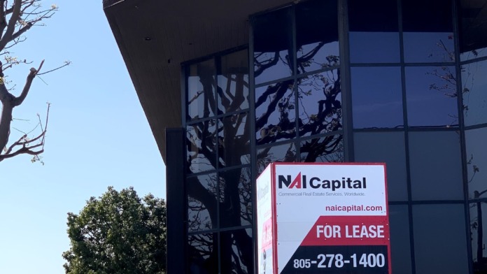 Close-up exterior view of VA Oxnard Community Based Outpatient Clinic signage on dark building facade