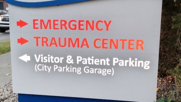 Facility identification sign with Ephraim McDowell logo and emergency department directional information