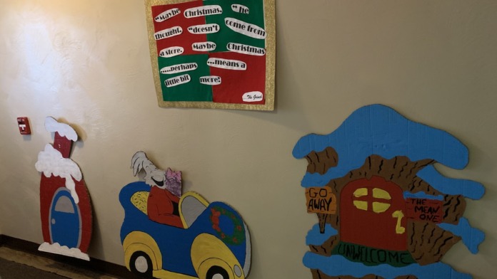 Interior hallway featuring festive holiday wall decorations with cartoon characters and seasonal ornaments