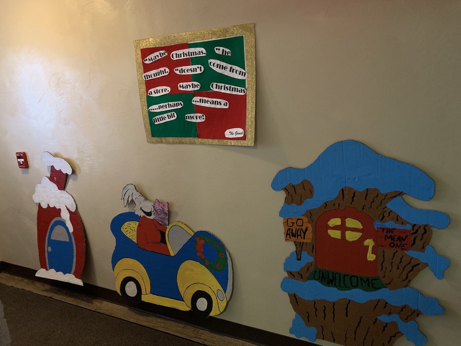 Interior hallway featuring festive holiday wall decorations with cartoon characters and seasonal ornaments