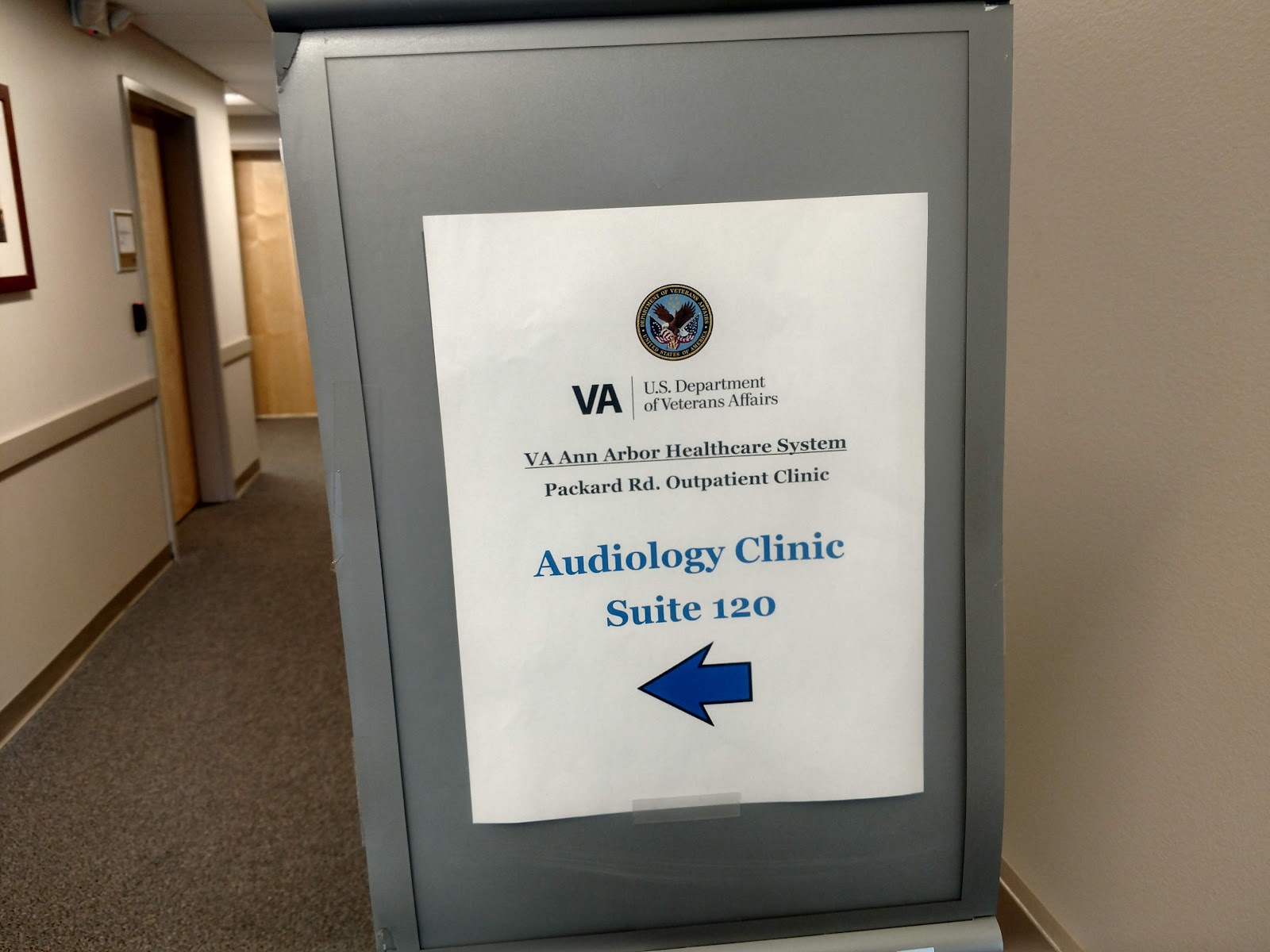 Interior hallway showing wayfinding signage for Audiology Clinic with VA Department of Veterans Affairs branding