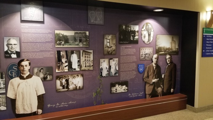 Interior hallway featuring purple-walled historical display with vintage photographs and institutional branding