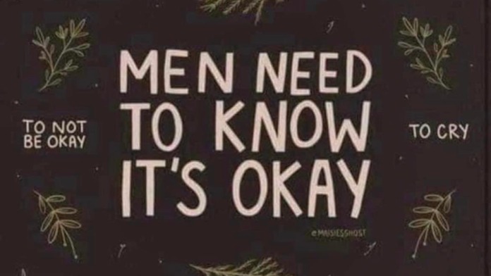 Interior wall art with supportive messaging about men's mental health, encouraging emotional awareness and seeking help