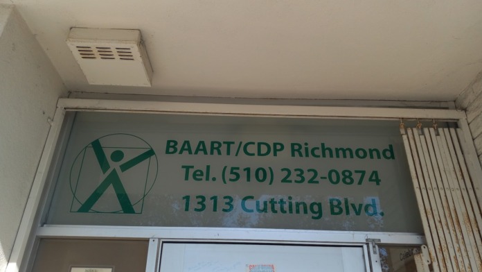 Interior view of entrance with BAART/CDP Richmond signage, address details, and posted notice board