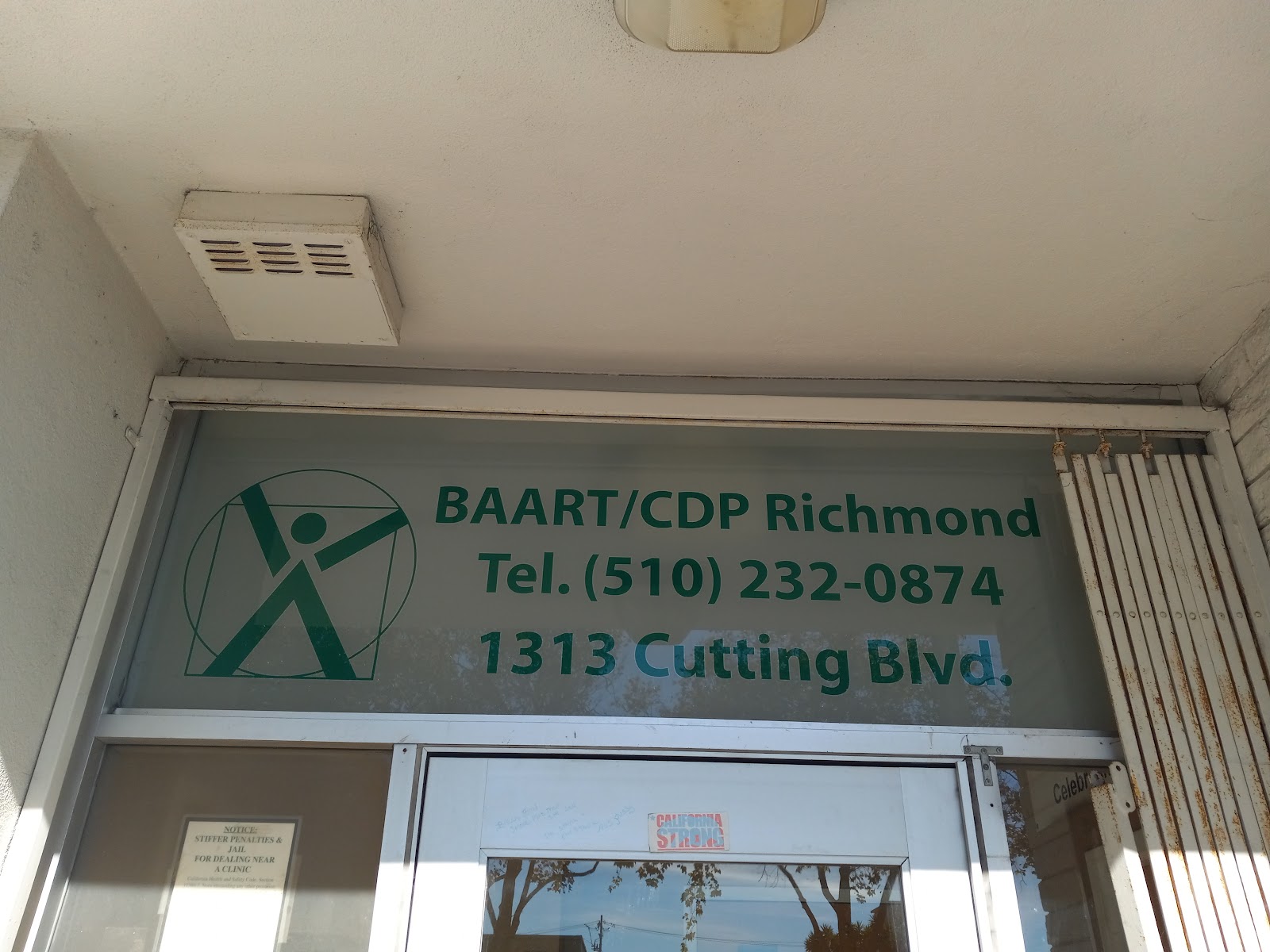 Interior view of entrance with BAART/CDP Richmond signage, address details, and posted notice board