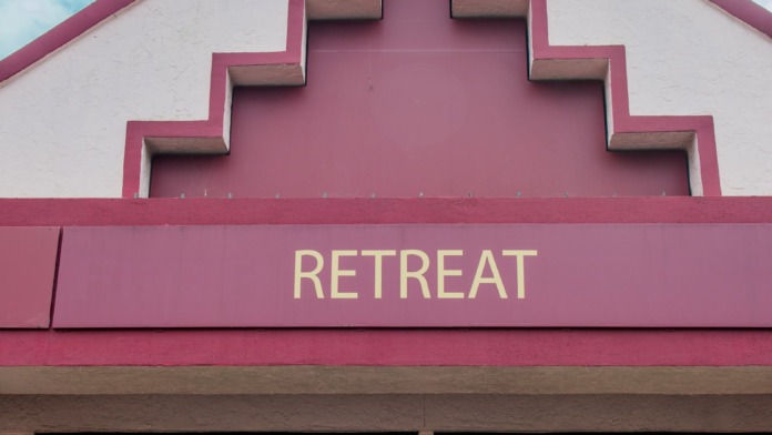 Exterior view of Retreat Behavioral and Mental Health Center showing distinctive pink and white architectural facade with facility signage and entrance doors