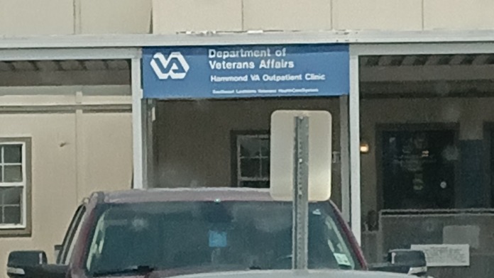 Exterior close-up of Hammond VA Outpatient Clinic entrance with Department of Veterans Affairs signage and glass entry doors