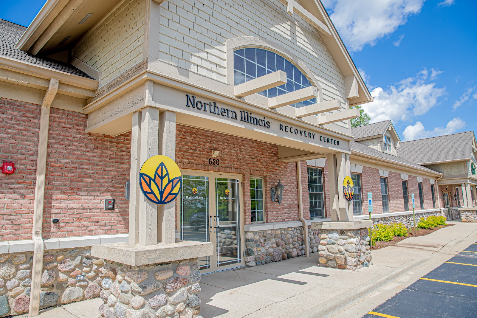 Exterior detail of Northern Illinois Recovery Center entrance showing address 620, brick facade, and facility logo signage