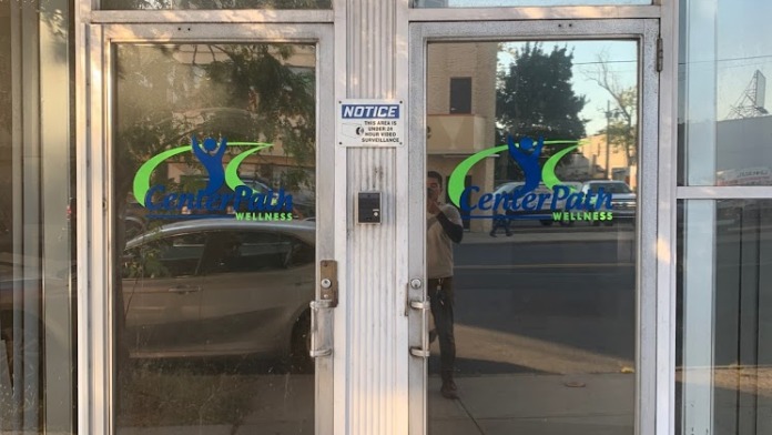 Exterior entrance doors displaying CenterPath Wellness facility logo and signage with glass facade