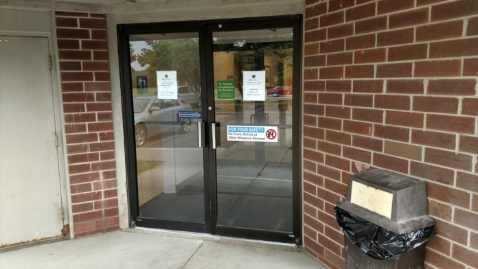 Exterior front of VA clinic building showing entrance doors, brick facade, windows, and facility identification signage