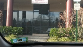 Exterior view of South Jersey Behavioral Health Resources building showing brick facade, entrance with signage, and accessible parking