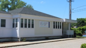 Exterior front view of white treatment center building with Cornell Scott Hill Health Center signage and main entrance