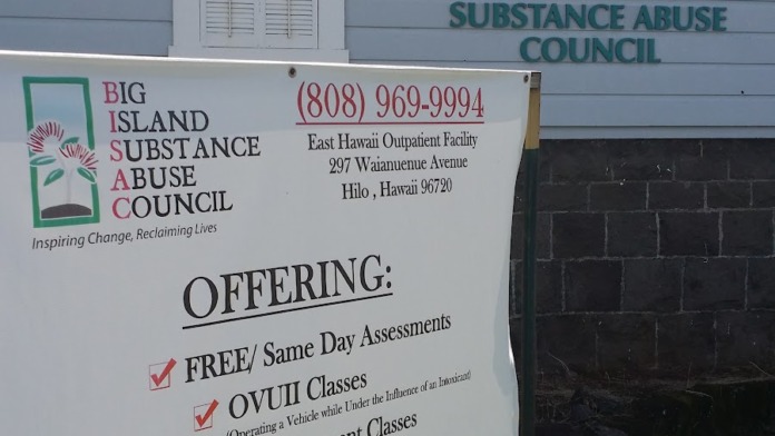 Exterior view of Big Island Substance Abuse Council building with facility name signage, logo, and information sign displaying services and contact details