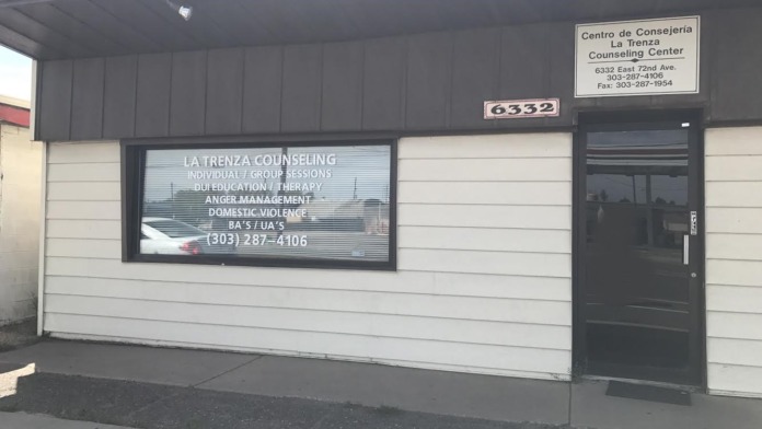 Exterior view of La Trenza Counseling Center storefront showing entrance door, service window with business information, and address signage