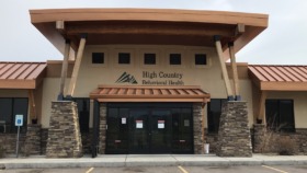 Exterior view of treatment facility main entrance with stone pillars, glass doors, and facility signage